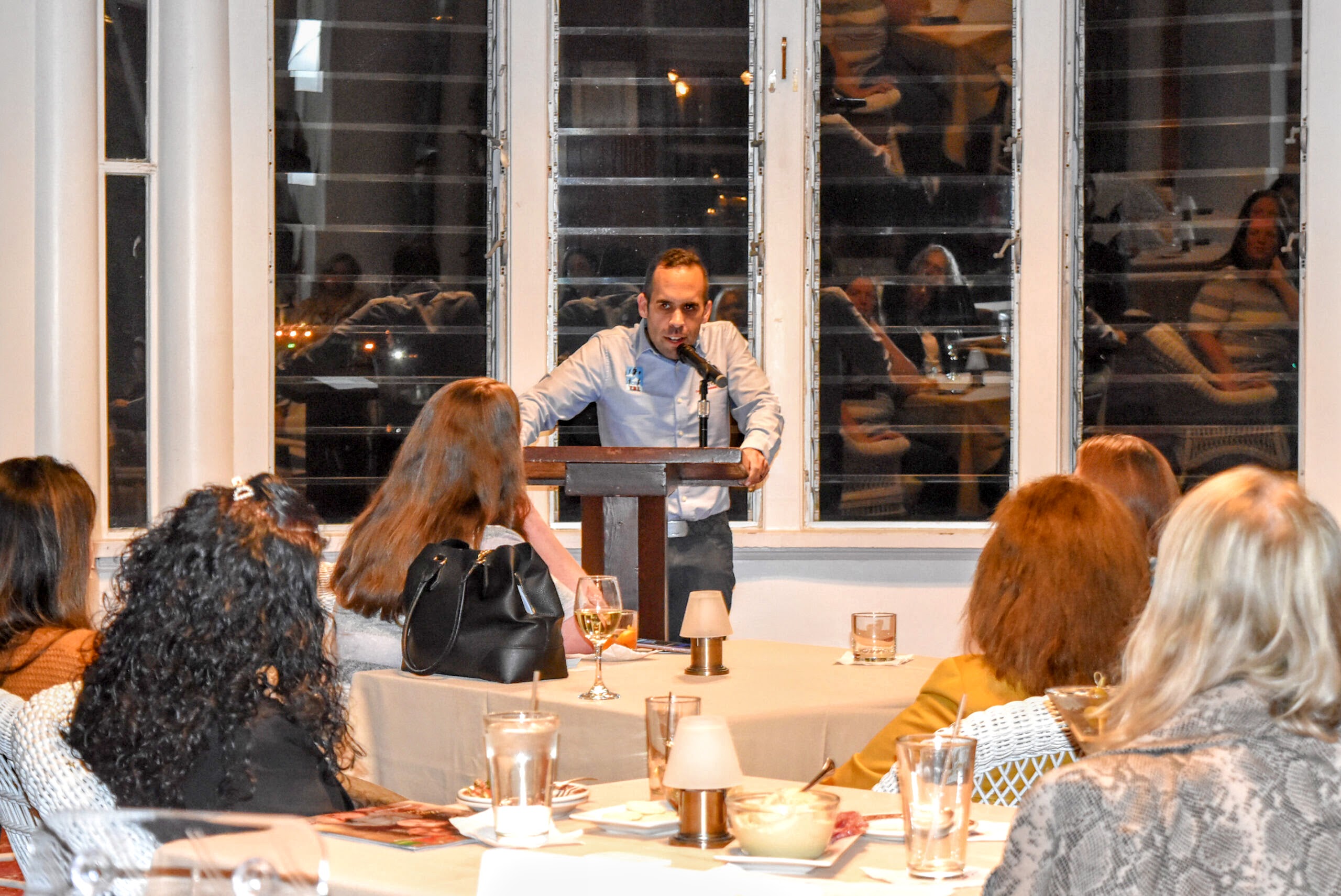 Joshua Pereira speaking at a Rhode Island business event